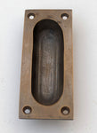 Oval Recessed Sliding Door Pull in Antique Brass