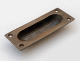 Oval Recessed Sliding Door Pull in Antique Brass